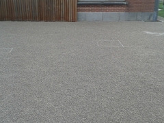 Oprit in nidagravel opgevuld met grijs/beige siergrind